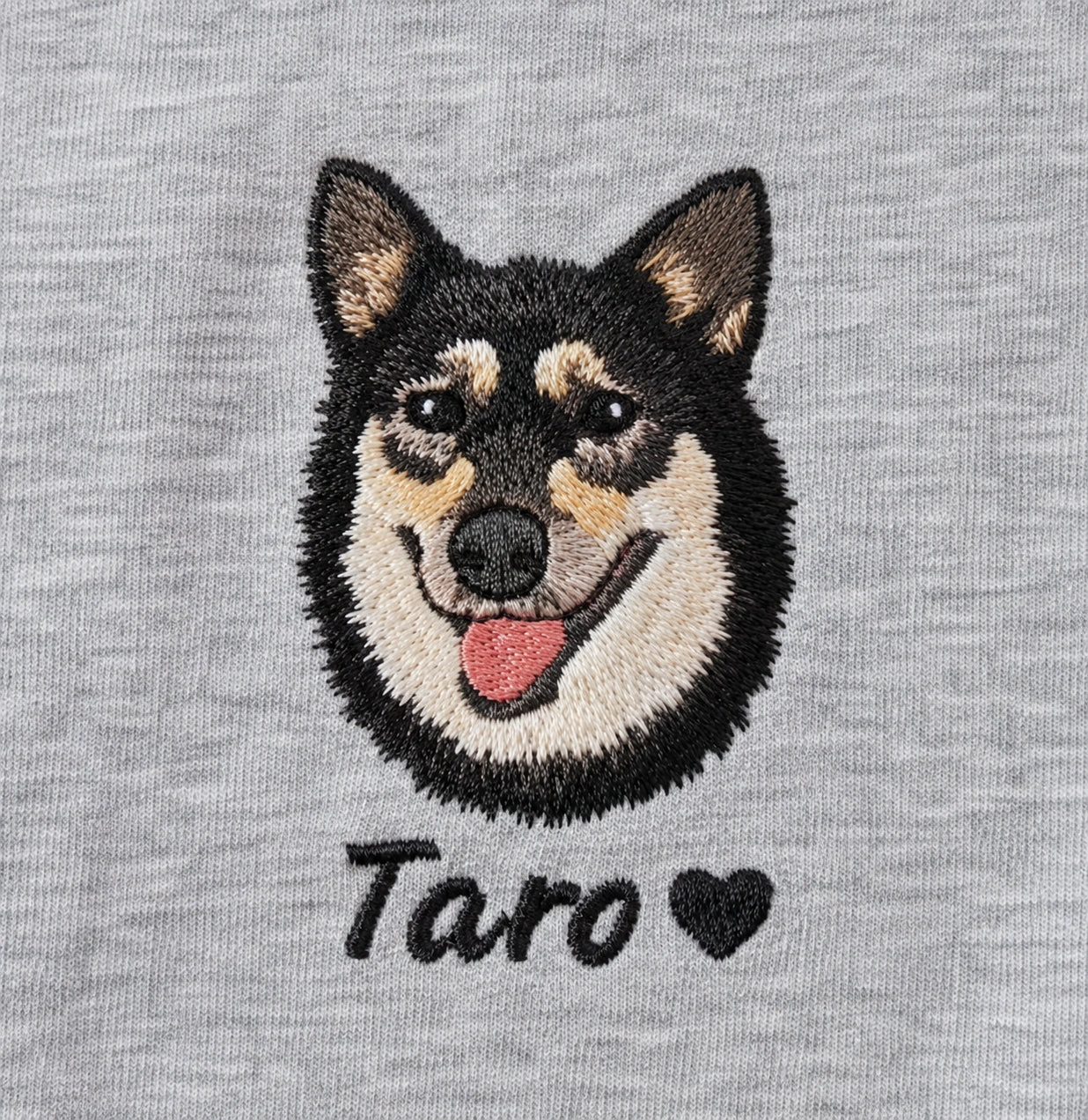 Black and tan dog recreated in embroidery